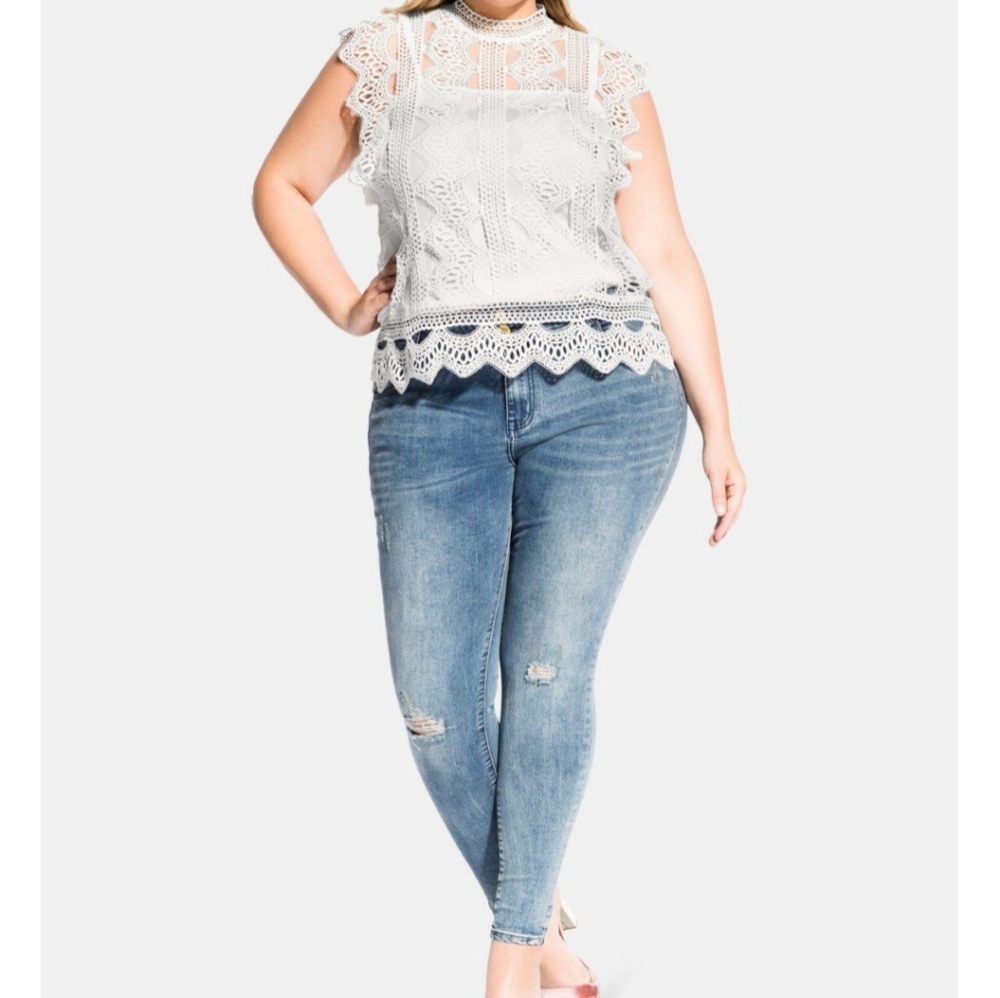 From City Chic.A high neckline with lace embroidered throughout the top size 20